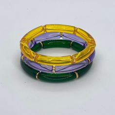 Say Happy Mardi Gras with this trendy acrylic purple, green and gold bracelet set. Bracelets are “one size fits most” and are designed to fit wrists up to 7.0”. Custom sizes available upon request. Please email designsby.kb@yahoo.com once your oder is placed. *Bracelets usually ship within 3-5 business days. Please be aware that due to the unique and handmade nature of each product, color, shapes, and bead sizes may vary slightly from the photos and description. Trendy Green Stretch Bracelet Stackable, Trendy Green Stackable Stretch Bracelet, Green Stackable Bangle Bracelets, Trendy Green Stretch Bangle Bracelet, Adjustable Green Beaded Plastic Bracelets, Adjustable Green Plastic Beaded Bracelets, Trendy Green Plastic Beaded Bracelets, Green Plastic Bracelet Jewelry, Green Plastic Beaded Bracelets As Gift