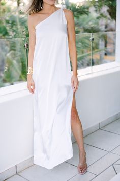 Crafted out of luxurious hammered satin and designed with a one shoulder silhouette featuring an adjustable tied strap, this Born To Love White Satin One Shoulder Maxi Dress will make you feel as if you were born to love. The side slit adds a touch of elegance to an already classic look. Material has no amount of stretch.Cam is wearing the small. One Shoulder Maxi Dress, Mint Julep Boutique, White Satin, Classic Looks, Make You Feel, One Shoulder, Perfect Fit, Maxi Dress, Satin