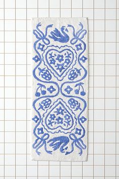 a blue and white towel hanging on a tiled wall