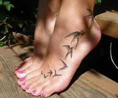 a woman's foot with birds on it