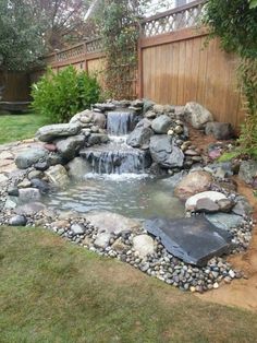 a small waterfall in the middle of a yard