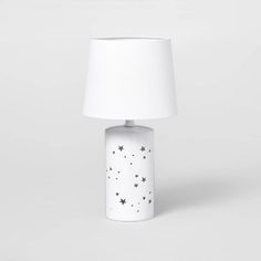 a white table lamp with stars on it