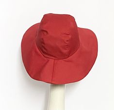 Wide Brim sun hat made with red cotton twill , lined in rayon print, the hat has a 2 section crown 3 1/2 " in length and a one piece 4" brim, a cotton band inside. One size fits most up to 23" Machine wash cold / hand dry Made in USA Press if needed / packable Adjustable Wide Brim Red Sun Hat, Fitted Sun Hat With Upf 50+ And Curved Brim, Adjustable Red Wide Brim Sun Hat, Fitted Sun Hat With Upf 50+, Wide Brim Red Bucket Hat For Summer, Red Wide Brim Bucket Hat For Summer, Red Brimmed Bucket Hat For Summer, Fitted Lined Hats With Curved Brim, Fitted Hats With Curved Brim And Lining