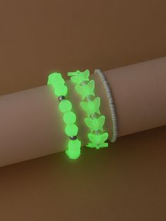 two bracelets with green glow on them