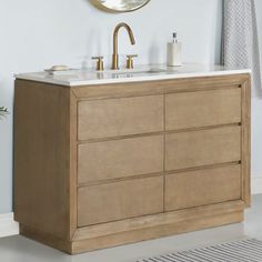 a bathroom vanity with two sinks and a mirror on the wall above it, along with a rug