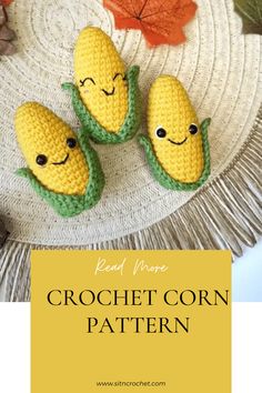 three crocheted corn cobs sitting on top of a white plate with autumn leaves