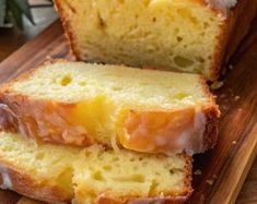 two slices of lemon bread sitting on top of a wooden cutting board