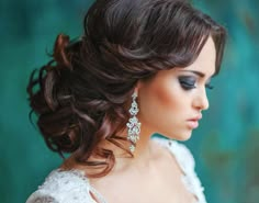 an image of a woman with long hair and earrings on her head, looking at the camera