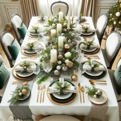 a dining room table set for christmas dinner with candles and greenery on the tables