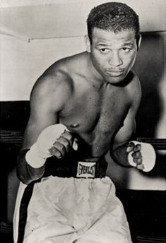 a black and white photo of a man wearing boxing gloves with the words sugar ray robinson on it