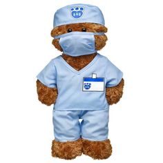 a teddy bear dressed as a nurse in blue scrubs and a mask on it's face