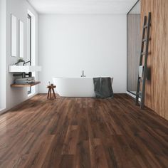 a bathroom with wooden flooring and white bathtub next to a ladder on the wall