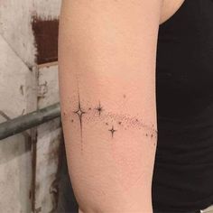 a woman with a star tattoo on her arm