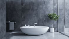 a large white bath tub sitting next to a tall plant in a room with concrete walls