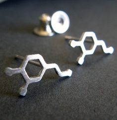 Ready to show off your inner nerd? These chemistry-themed stud earrings celebrate the chemical formula for dopamine, a naturally-occurring neurotransmitter associated with pleasure cravings, motivation, and reward. Adorn your lobes with the coolest stud earrings.Sizing∞ Tiny Dopamine Molecules (approx 8mm x 4mm)∞ Medium Dopamine Molecules (approx 11mm x 5mm)∞ Large Dopamine Molecules (approx 14mm x 7mm)The Details∞ Artisan handmade∞ Choose from sterling silver, 14k gold-filled, or solid 14k yell Dopamine Molecule, Serotonin Molecule, Puzzle Piece Necklace, Artisan Jewelry Handmade, Gold Filled Earrings, Gold Earring, Antique Earrings, Earring Sale, Yellow Gold Earring