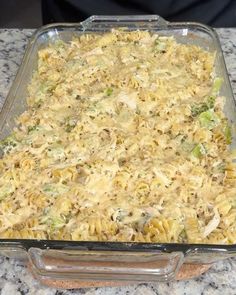 a casserole dish with noodles and broccoli in it on a counter