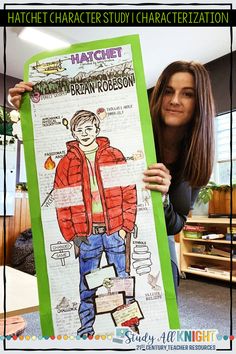 a woman holding up a poster with an image of a person wearing a red jacket