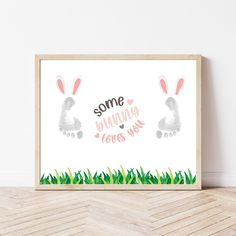 some bunny loves you art print in a wooden frame on the floor next to a white wall