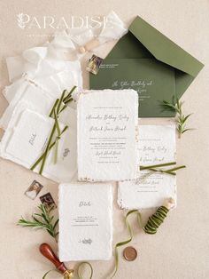 the wedding stationery is laid out on top of each other