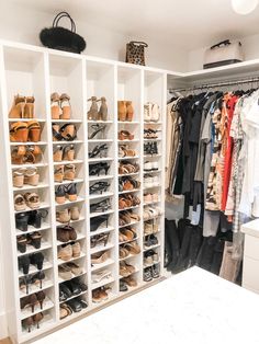 a closet filled with lots of different types of shoes and clothes hanging on shelves next to a counter top