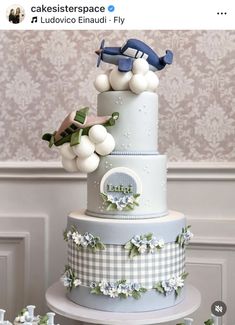 a three tiered cake with blue and white decorations