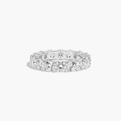 a white gold ring with round cut diamonds on the inside and outside, set in 18k white gold