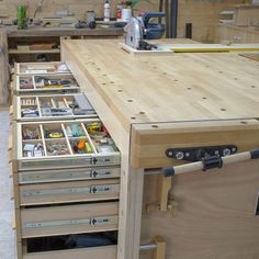 a workbench with lots of drawers and tools in the drawer compartment on it