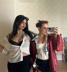 two women are taking a selfie in the mirror