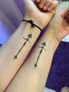 two people with matching tattoos on their arms