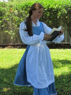 a woman in a blue dress reading a book