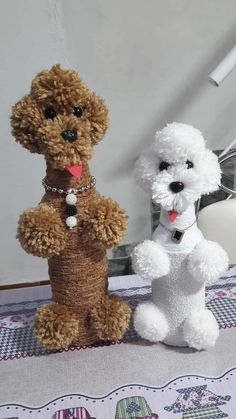 two stuffed animals sitting on top of a table