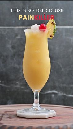 this is an image of a drink with pineapple on the rim and garnish