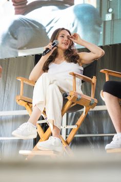 a woman sitting in a chair with a microphone