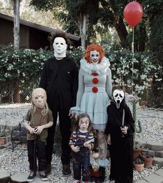 a group of people in halloween costumes standing next to each other