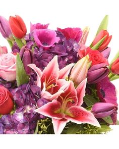 a vase filled with lots of purple and red flowers