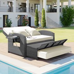 an outdoor lounge chair next to a swimming pool