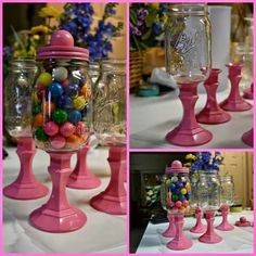 there are many glass vases with candy in them