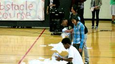 some kids are playing with paper on the court