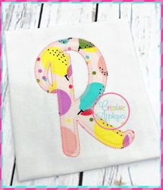 the letter p is made up of colorful fabric and has an appliqued design