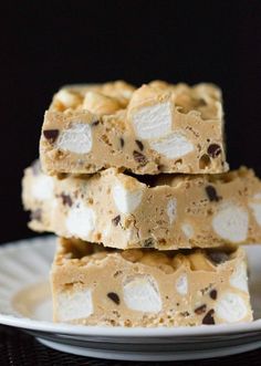 three pieces of peanut butter fudge bars stacked on top of each other in front of a black background