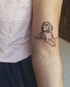 a woman with a dog tattoo on her arm