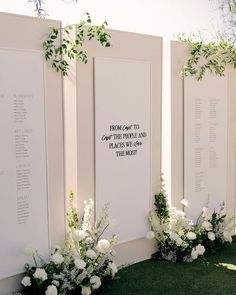 white flowers and greenery line the side of a wall at a wedding ceremony in california