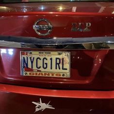 a red car with a license plate that says new york girl giants on the front