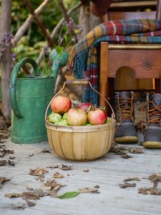 a basket filled with apples sitting on top of a wooden table