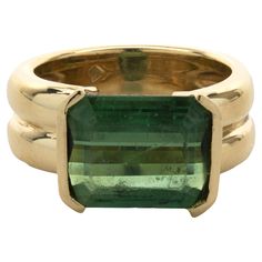 Designer: custom Material: 18K yellow gold Green Tourmaline: 1 emerald cut = 4.44ct Dimensions: ring top measures 10.4mm Ring Size: 7.5 (complimentary sizing available) Weight: 12.10 grams Physical And Chemical Properties, Green Tourmaline Ring, Green Emerald Ring, Green Purse, Tourmaline Ring, Green Tourmaline, Emerald Ring, Ring Size 7, Emerald Cut