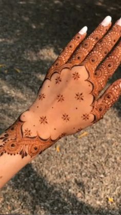 a woman's hand with henna on it