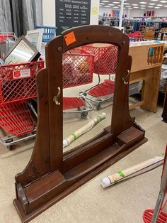 a mirror sitting on top of a wooden stand in a store next to other items