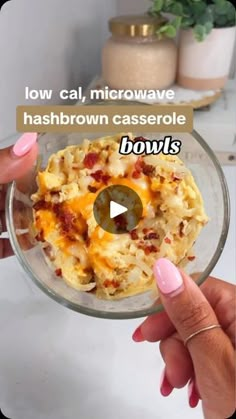 a person holding a bowl with food in it and the words low cal, microwave hashbrown casserole bowls