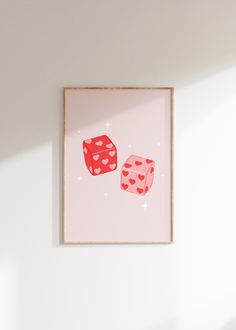 two red dices sitting on top of a pink wall next to a white chair