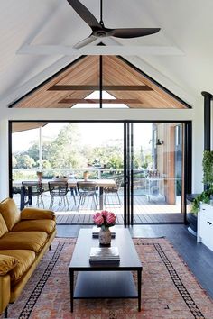 a living room filled with furniture and a ceiling fan